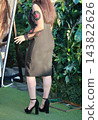 Woman Standing In Garden Wearing Balck High Heels 143822626