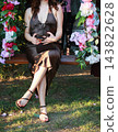 Woman Sitting Gracefully On Flower Swing 143822628