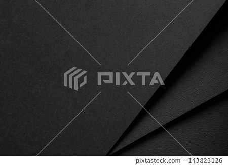 Folded black paper texture, diagonal fold with crease and shadow. Dark layered sheet, matte surface close up background. Abstract minimalistic designer paper, sleek chic style. Folded black paper texture, diagonal fold with crease and shadow. Dark layered sheet, matte surface close up background. Abstract minimalistic designer paper, sleek chic style. 143823126