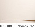 Beige cream paper texture background, curved fold with gentle curl line. Matte surface close up, bent edge wave shape with fine grain. Designer paper backdrop, pastel smooth neutral tone. 143823152