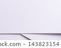 Lavender paper texture, folded sheet with diagonal line and shadow. White matte surface, bent edge in close up with fine grain. Pastel designer paper backdrop, minimalist geometric fold. 143823154