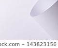 Curled lavender paper texture, bent edge with wave shape and curl. White matte sheet surface close up, diagonal fold line on fine grain. Pastel designer paper backdrop, smooth minimalistic 143823156