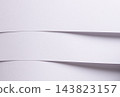Bent lavender paper texture, curved fold with wave shape and edge curl. Matte white sheet surface close up, diagonal line on fine grain. Pastel designer paper backdrop, soft elegant 143823157