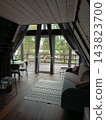Interior of a room with a wooden floor and a window in a glamping pod. 143823700