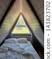 Interior of a attic bedroom in a glamping pod 143823702