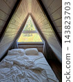 Wooden attic bedroom in A-frame cabin 143823703