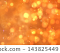 A sparkling bokeh effect and a starry orange background. 143825449