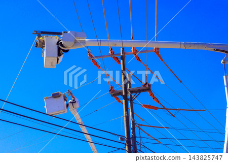 Bucket trucks reach power lines on utility pole during service, line works work in city. Bucket trucks reach power lines on utility pole during service, line works work in city. 143825747