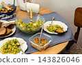 Quinoa with green peas, arugula, cauliflower, and broccoli is served with liver pate at a dining table during breakfast 143826046