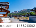 Traditional Korean Hanok Houses and Tiled Roofs against Bukhansan Mountain in Eunpyeong Hanok Village, Seoul 143826602
