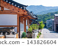 Traditional Korean Hanok Houses and Tiled Roofs against Bukhansan Mountain in Eunpyeong Hanok Village, Seoul 143826604