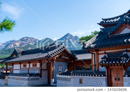 Traditional Korean Hanok Houses and Tiled Roofs against Bukhansan Mountain in Eunpyeong Hanok Village, Seoul Traditional Korean Hanok Houses and Tiled Roofs against Bukhansan Mountain in Eunpyeong Hanok Village, Seoul 143826606
