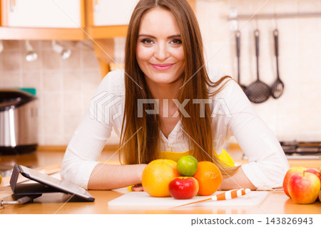 Woman housewife in kitchen using tablet Woman housewife in kitchen using tablet 143826943