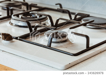 Clean gas kitchen stove on white metal Clean gas kitchen stove on white metal 143826978