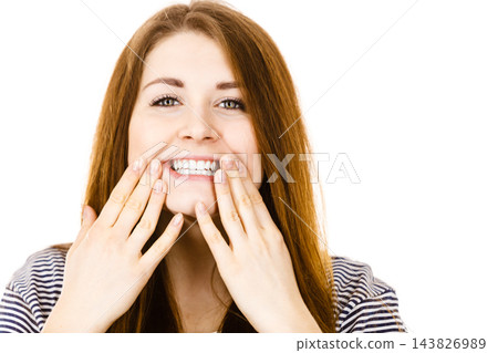 Portrait of beautiful young woman showing teeth Portrait of beautiful young woman showing teeth 143826989