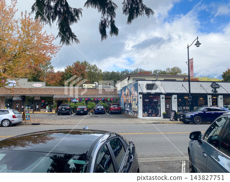 Small town main street with retail shops, parked cars, and autumn trees on a cloudy day - Snoqualmie WA - October 10, 2026 Small town main street with retail shops, parked cars, and autumn trees on a cloudy day - Snoqualmie WA - October 10, 2026 143827751