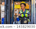 Woman worker at forklift driver happy working in industry factory logistic ship. 143829030