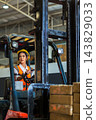 Woman worker at forklift driver happy working in industry factory logistic ship. 143829033