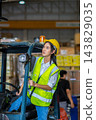 Woman worker at forklift driver happy working in industry factory logistic ship. 143829035