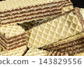 Crispy chocolate layered wafers macro close up photo 143829556