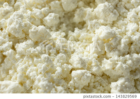 Fresh organic cottage cheese texture background close up Fresh organic cottage cheese texture background close up 143829569