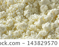 Crumbly white curd cheese background with copy space 143829570