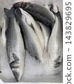 Fresh whole sea bass arranged on crushed ice in a chilled seafood market display 143829695