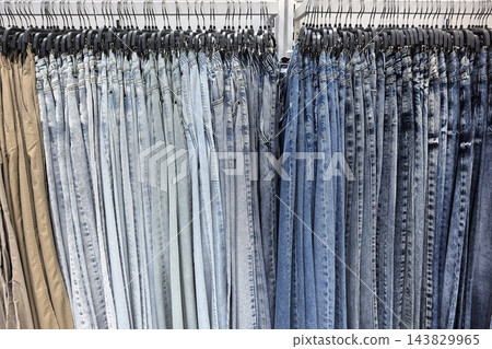 Fashionable denim collection in a vibrant retail store during busy afternoon 143829965