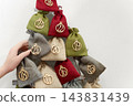 Christmas advent calendar with numbered fabric gift bags 143831439