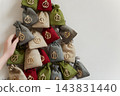 Handmade christmas advent calendar with numbered fabric countdown bags 143831440
