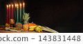Kwanzaa kinara and harvest offerings in a festive holiday banner 143831448