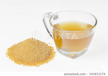 Drink of piloncillo and ground piloncillo, on white background Drink of piloncillo and ground piloncillo, on white background 143831574