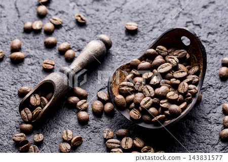 Roasted coffee beans with wooden spoon, closeup image, space for text Roasted coffee beans with wooden spoon, closeup image, space for text 143831577