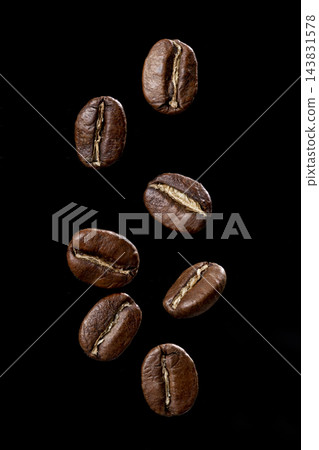 Roasted coffee beans from Colombia suspended in the air, Arabica variety. Roasted coffee beans from Colombia suspended in the air, Arabica variety. 143831578