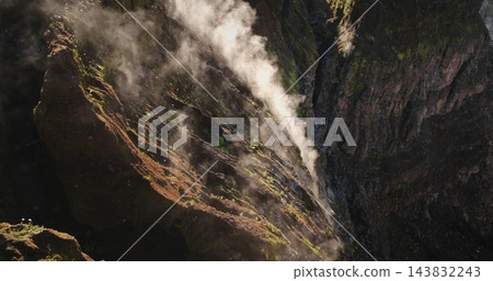 Ambrym Island's Benbow and Marum volcano crater rim showing a column of steam and gas rising from the deep caldera, highlighting the raw power and geological activity of the stratovolcano Ambrym Island's Benbow and Marum volcano crater rim showing a column of steam and gas rising from the deep caldera, highlighting the raw power and geological activity of the stratovolcano 143832243