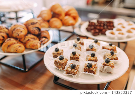 Assorted pastries and mini desserts on a buffet table 143833357