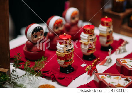 Traditional Christmas nutcracker and festive holiday ornaments on a market display 143833391
