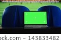 Green screen, laptop and football stadium as blank chroma key display stands between blue seats facing soccer pitch. Screen replacement, sports marketing and advertising support editable content. 143833482