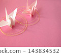 White and pink origami cranes on a pink background 143834532