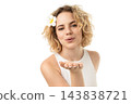 Woman playfully blows kiss with flower, isolated on white, PNG 143838721