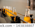 Basil or chia seed beverages with pomegranate undergo quality filling into transparent bottles 143838807