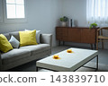 A living room bathed in soft natural light. 143839710