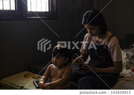 Mother Feeding Her Toddler In Bedroom Mother Feeding Her Toddler In Bedroom 143839915