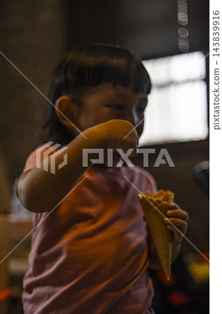 Toddler Scooping And Eating Ice Cream Toddler Scooping And Eating Ice Cream 143839916
