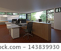 An open-plan office featuring rows of white desks, black chairs, computer monitors, and large windows facing trees. 143839930