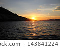 Golden sunset reflection path on Adriatic Sea near rocky coast in Croatia 143841224