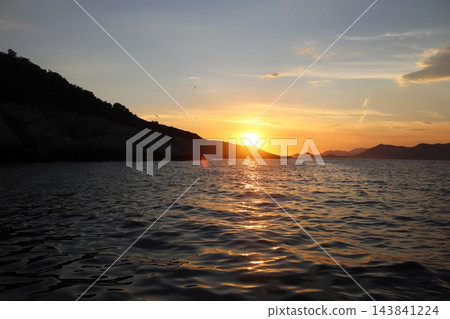 Golden sunset reflection path on Adriatic Sea near rocky coast in Croatia Golden sunset reflection path on Adriatic Sea near rocky coast in Croatia 143841224