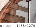Crack and impact mark on a transparent glass window pane installed inside an old stone archway  143841279