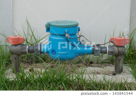Water meter for measuring water usage is installed in front of the house. Water meter for measuring water usage is installed in front of the house. 143841544