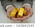 Asian woman holding gold bar in finance business. 143841545